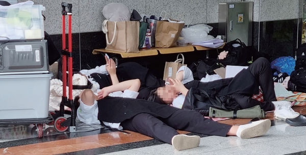 지난달 20일 (사)한국조리협회가 주최한 대한민국 국제요리&제과경연대회에 참가한 학생들이 대기할 공간이 없어 차가운 대리석 맨바닥에 드러누워 휴식을 취하고 있다.