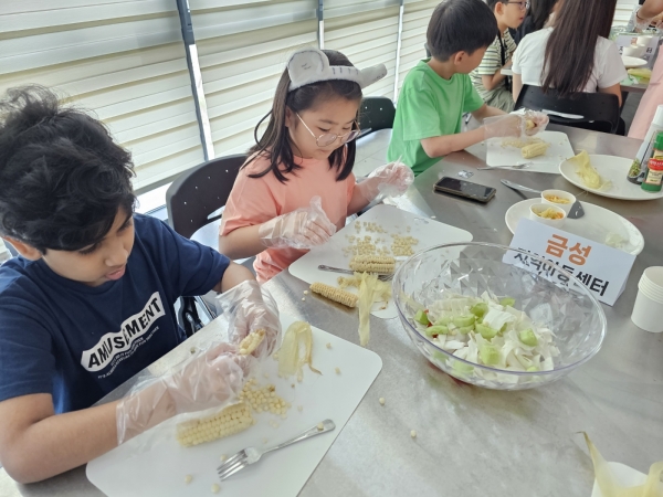 유성구센터가 진행한 '꾸러기 건강탐험대' 프로그램에 참여한 어린이들이 옥수수 샐러드 파스타를 만들어보는 모습.